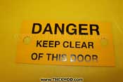 Plate - Danger keep clear of this door - FV775576